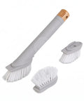 Set of cleaning brushes with gray handles and white bristles on a white background