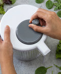 Person spinning a turning wheel on a salad spinner 