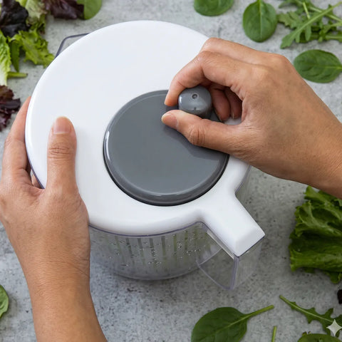 Person spinning a turning wheel on a salad spinner 