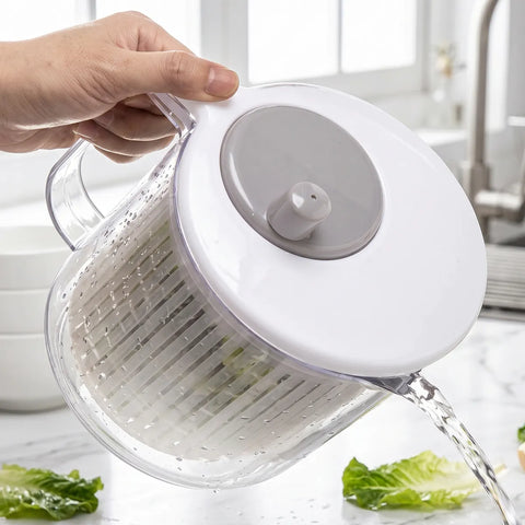 Hand using a salad spinner with lettuce on a kitchen counter