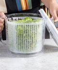 Person washing greens in a salad spinner