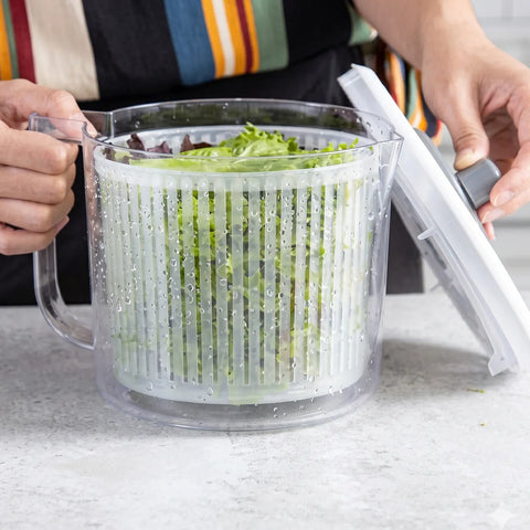Person washing greens in a salad spinner