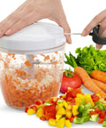 Handheld vegetable chopper with chopped vegetables on a white background
