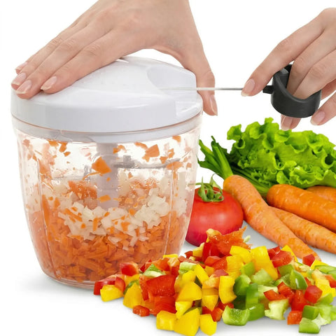 Handheld vegetable chopper with chopped vegetables on a white background