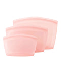 Set of three pink silicone pouches on a white background