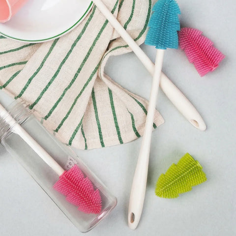 Cleaning tools including brushes and a cloth on a light surface