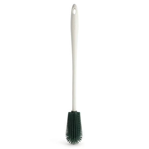 Cleaning brush with a white handle and green bristle head on a white background