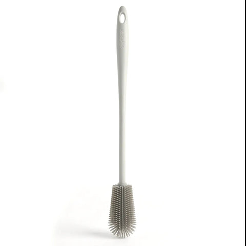 Gray silicone kitchen brush with a long handle on a white background