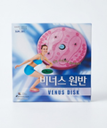 Venus Disk exercising rotating disk in its retail packaging, featuring a pink circular device with foot-shaped massage nodes on a blue and white background with an illustration of a woman in a blue swimsuit.