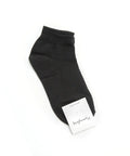 Black sock with a brand label on a white background