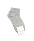 Gray ankle sock with a brand tag on a white background