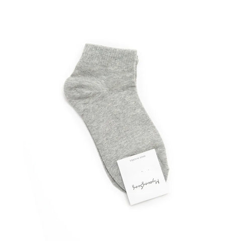 Gray ankle sock with a brand tag on a white background