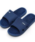 Pair of blue massage slippers on a white background