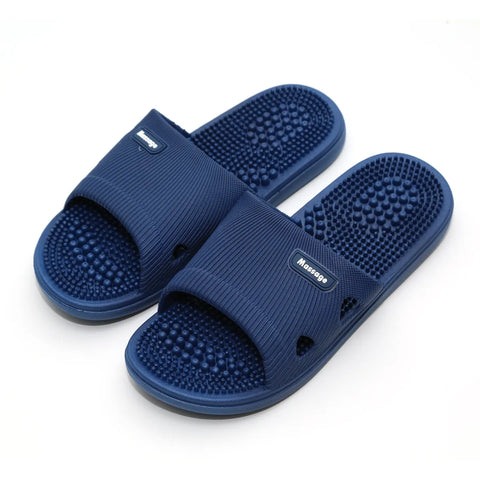 Pair of blue massage slippers on a white background