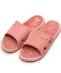 Pair of pink massage slippers on a white background
