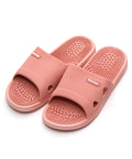 Pair of pink massage slippers on a white background