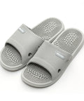 Pair of gray acupressure slippers on a white background
