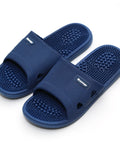 Pair of blue massage slippers on a white background