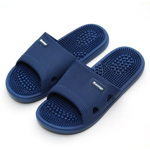 Pair of blue massage slippers on a white background