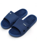 Pair of blue massage slippers on a white background