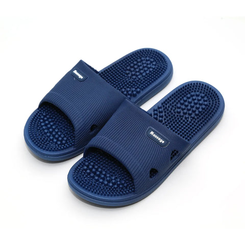 Pair of blue massage slippers on a white background