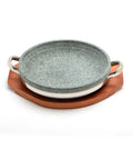 Stone bowl with stainless steel handles with wooden base on a white background
