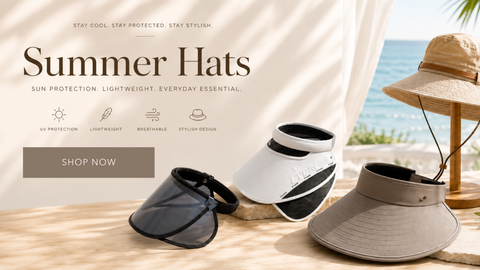 Four summer hats displayed on a beach-style set: a black visor with clear shield, a white visor with black trim, and a beige sun visor. A straw hat sits on a stand in the background, with ocean and palm imagery behind them. The title says 'Summer Hats' and a 'SHOP NOW' button underneath.
