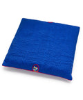 Blue square seat cushion with an embroidered design on a white background
