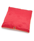 Red square seat cushion with an embroidered design on a white background