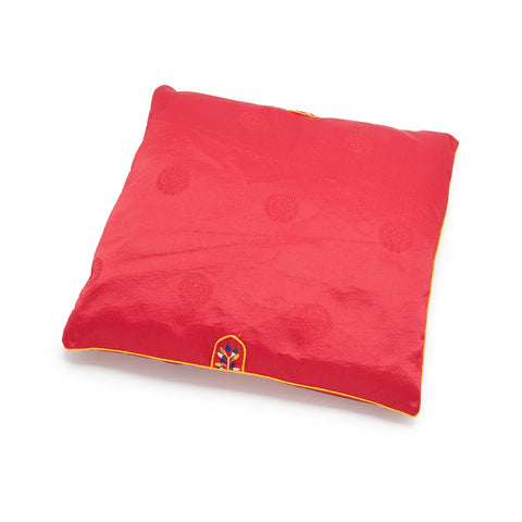 Red square seat cushion with an embroidered design on a white background