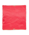 Red square seat cushion with an embroidered design on a white background
