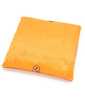 Orange square seat cushion with a embroidered decoration on a white background