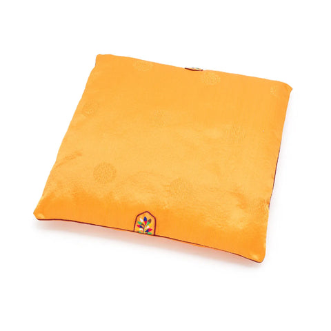 Orange square seat cushion with a embroidered decoration on a white background