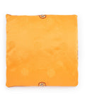 Yellow square seat cushion with embroidered patterns on a white background