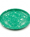 An oval green plate with a white speckled pattern, photographed from a top-down angle on a white background.