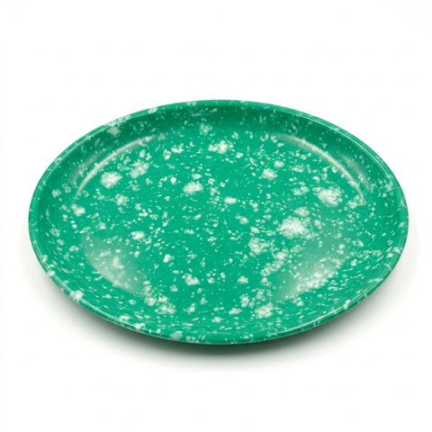 An oval green plate with a white speckled pattern, photographed from a top-down angle on a white background.