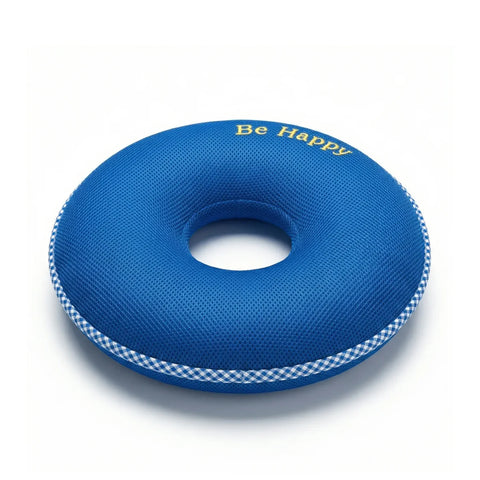 Blue donut cushion with 'Be Happy' text on a white background