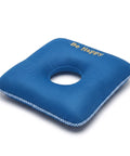 Blue donut pillow with 'Be Happy' text on a white background
