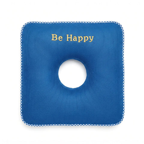 Blue donut cushion with a circular hole and 'Be Happy' text on a white background