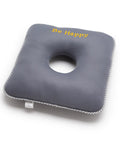 Gray square donut pillow with a circular hole and 'Be Happy' text on a white background