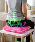 Person sitting on a pink cushion with a digital overlay of a spine and pelvis.