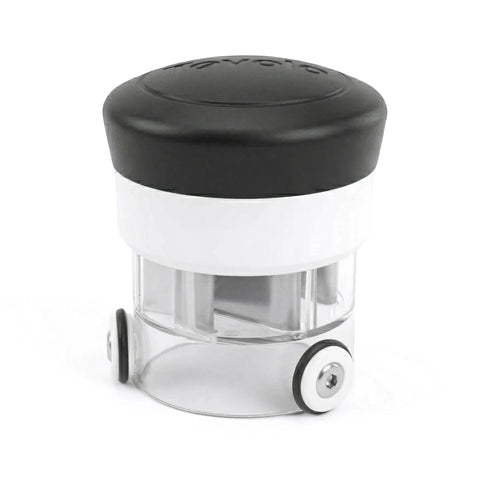 Small cylindrical manual food chopper with a black lid on a white background