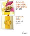 Promotional graphic for a yellow electric spin dryer with a rotary timer dial, showing two inset photos of use: one with gloved hands placing food into the tray and one close-up of the dial. Korean text describes features and usage, and the brand name titanium appears at the bottom right.