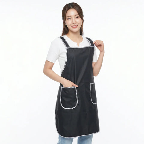 Woman wearing a black apron with white trim on a white background