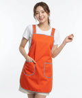 Woman wearing an orange apron on a white background