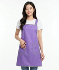 Woman wearing a purple apron on a white background