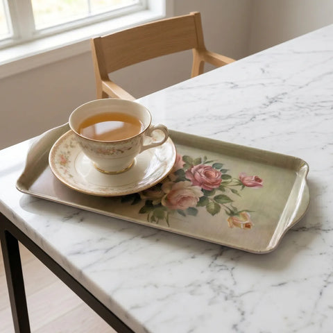 Teacup and saucer on a floral tray on a marble table