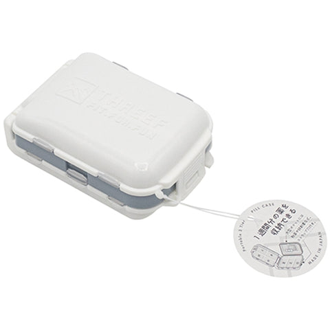A white and gray pocket-sized travel toothpick holder case with a hanging paper tag, shown on a plain white background.