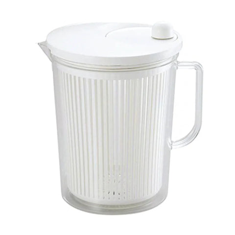 Clear salad spinner with handle and white lid on a white background