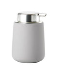 A modern cylindrical pump dispenser with a matte light gray body and a polished silver stainless steel pump head, shown on a solid white background.